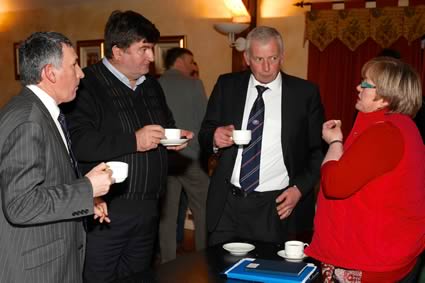 Blue Cattle Breeders Club secretary Libby Young briefs, from left, Harold McKee, Alan Cleland and Ivan Gordon on plans for the coming year 